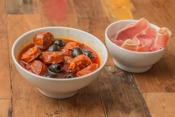 Chorizo al cava with black olives — Stock Photo, Image