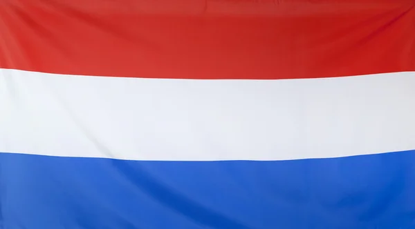 Hollanda bayrağı gerçek kumaş — Stok fotoğraf