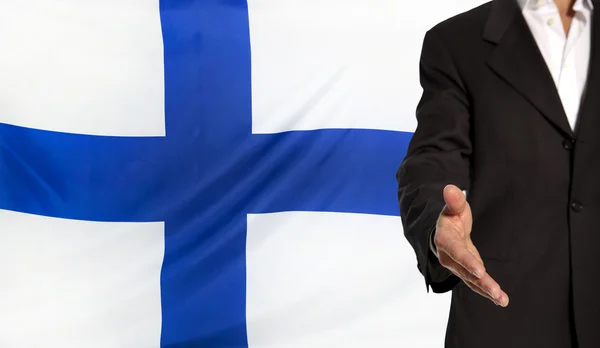 Offene Hand und Finnland-Fahne im Hintergrund — Stockfoto