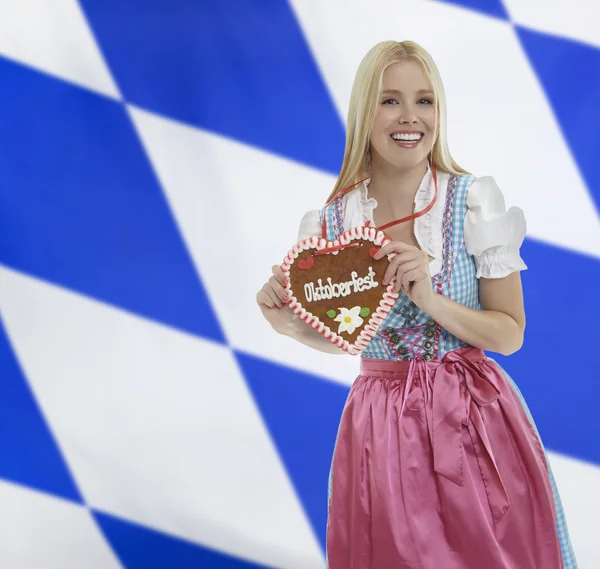 Smiling bavarian woman with Oktoberfest heart — Stock Photo, Image