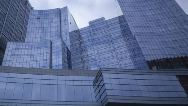 Blue glass skyscrapers with clouds passing by — Stock Video