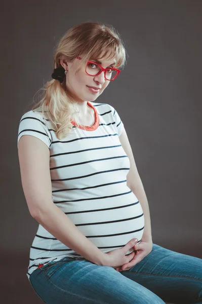 Happy pregnant woman watching her naked belly — Stock Photo, Image