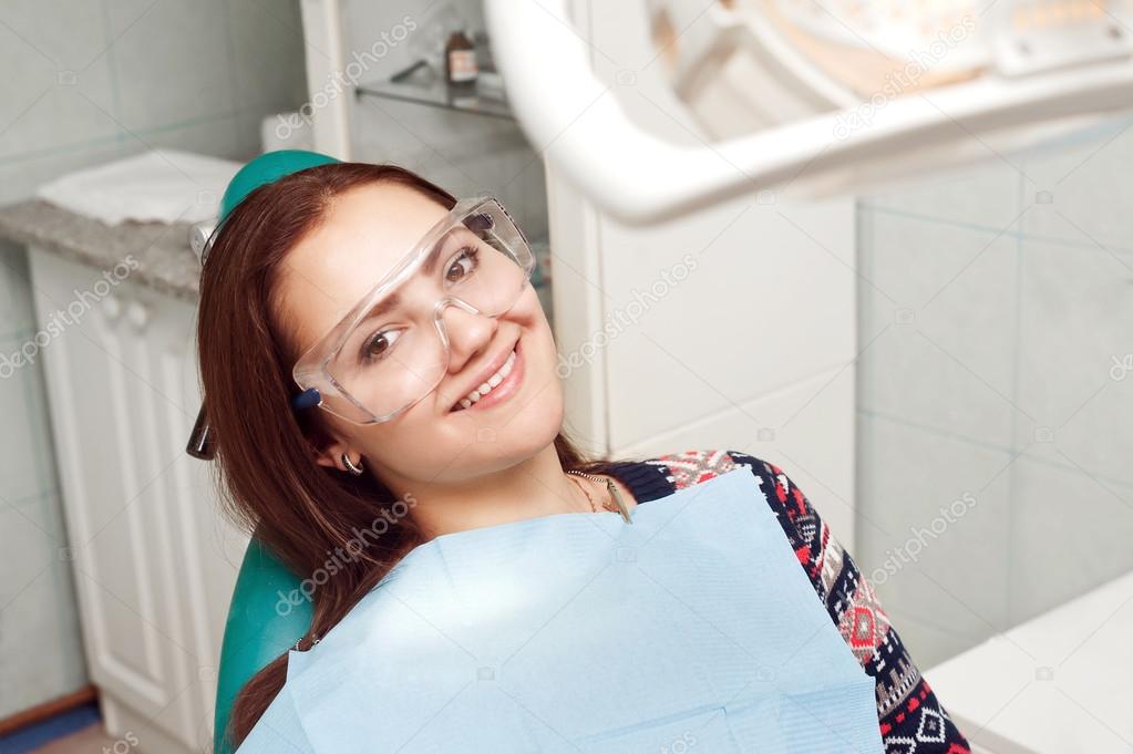 Young woman visiting the dentist and smiling