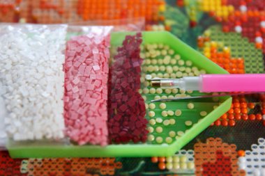 Preparation of tools, acrylic rhinestones, tweezers and pen, before starting work on 3D painting