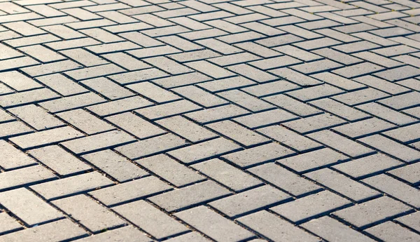 Paving tiles of gray color laid geometrically correct pattern for walking in the fresh air