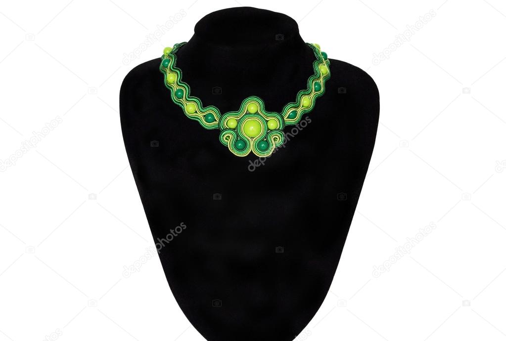 Green necklace on a rack
