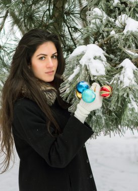 Kız bir köknar ağacı süsle