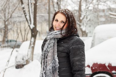 Happy woman walks on snowfall