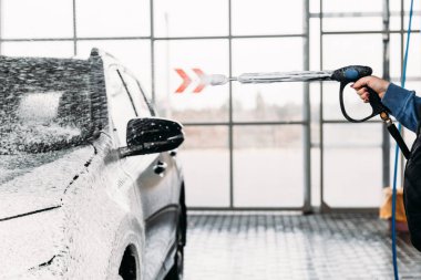 Kadın arabasını oto yıkama istasyonunda yıkıyor. Araba yıkama servisi.. 