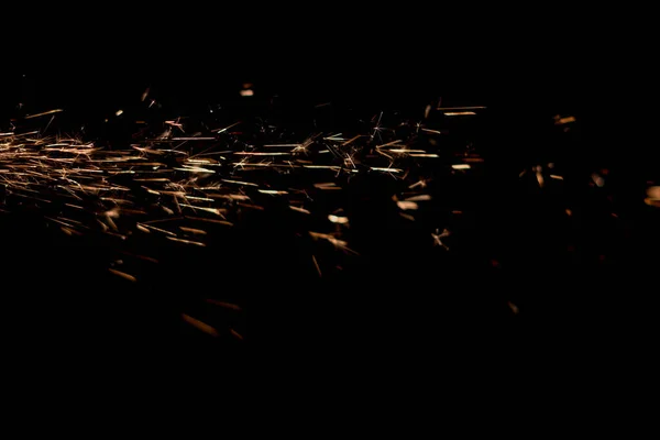 Glowing Flow of Sparks in the Dark. Fire sparks on a dark background — Stock Photo, Image