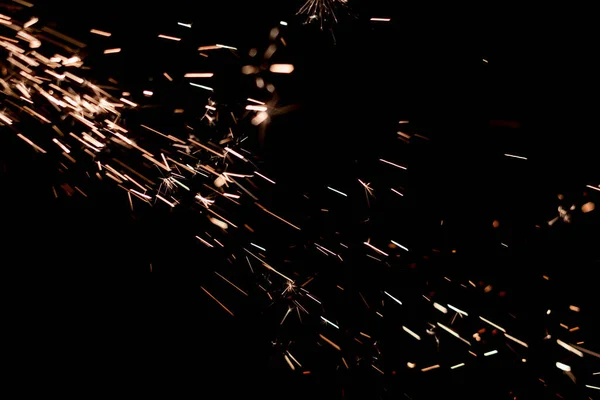 Glowing Flow of Sparks in the Dark. Fire sparks on a dark background — Stock Photo, Image