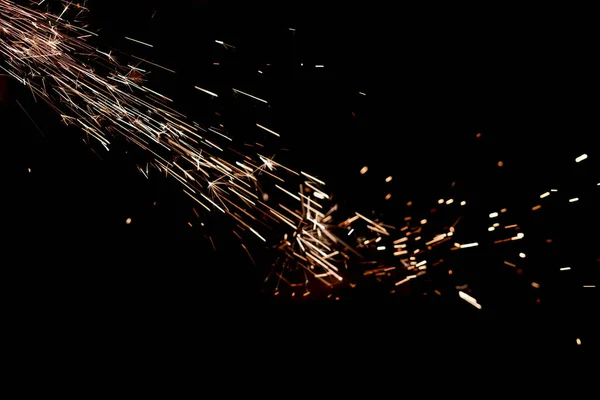 Glowing Flow of Sparks in the Dark. Fire sparks on a dark background — Stock Photo, Image