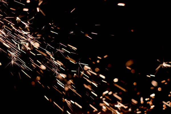 Glowing Flow of Sparks in the Dark. Fire sparks on a dark background — Stock Photo, Image