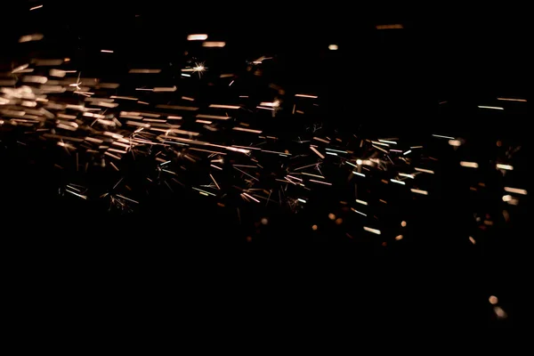 Glowing Flow of Sparks in the Dark. Fire sparks on a dark background — Stock Photo, Image