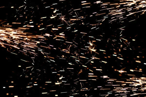 Glowing Flow of Sparks in the Dark. Fire sparks on a dark background — Stock Photo, Image