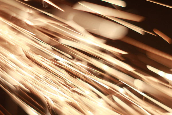 Glowing Flow of Sparks in the Dark. Fire sparks. High quality photo