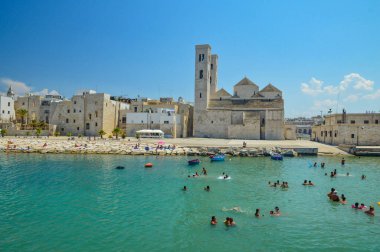 Molfetta, İtalya, 06 / 25 / 2017. Puglia bölgesindeki tarihi bir kasabanın plajında yaşayan insanlar..