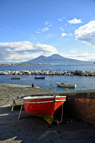 Naples, Italy, December 2020. People walking along the city's waterfront on a sunny winter day.