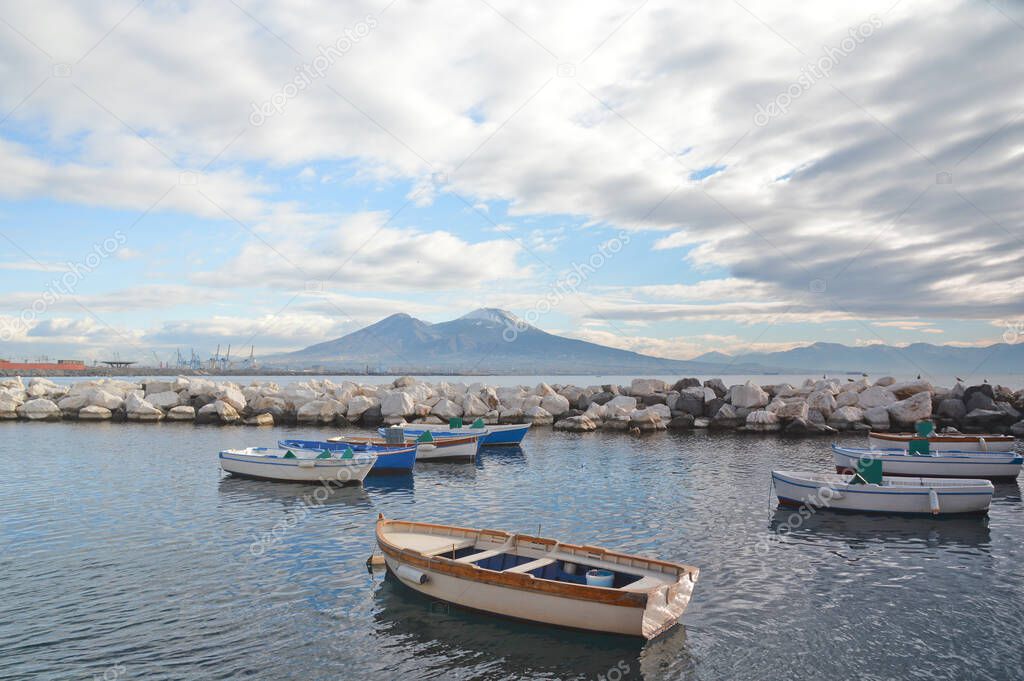 Fishing boats in the oldest part of the harbor in Naples city, italy.
