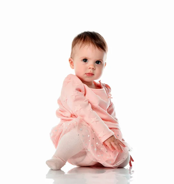 Adorable little baby girl smiling, sitting on the floor, studio shot, isolated on white Stock Photo