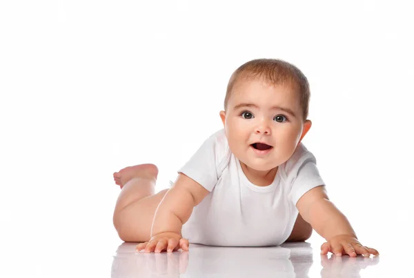 Smiling baby girl crawls on all fours and laughs out loud. — Stock Photo, Image