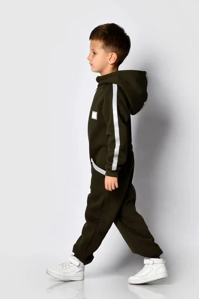 Boy wearing black warm jumpsuit in motion shot — Stock Photo, Image