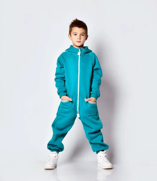 Stylish fashionable portrait of a little school boy dressed in sports overalls and white sneakers. — Stock Photo, Image