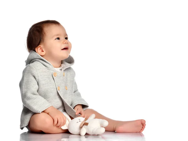 Smiling happy baby in knitted wear and toy bunny — Stock Photo, Image