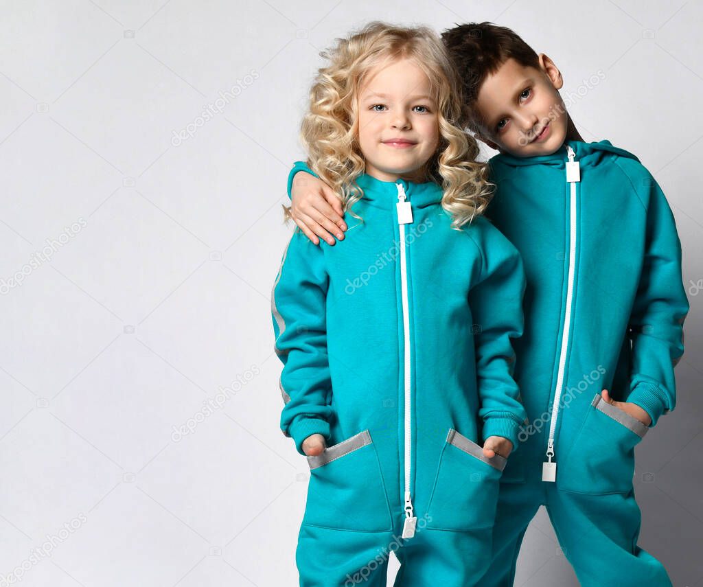 Fashion stylish children, boy and girl studio portrait