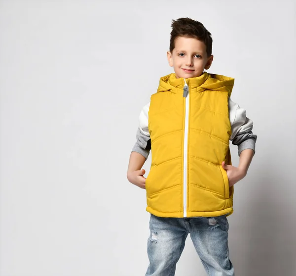 Fashionable teen boy posing in autumn waistcoat, isolated on light — Stock Photo, Image