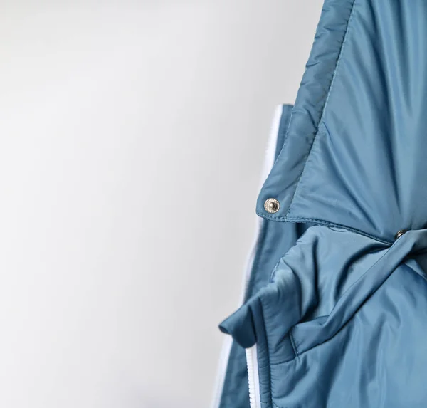 close-up of the hood from a blue padded jacket. there is a place for your advertisement.