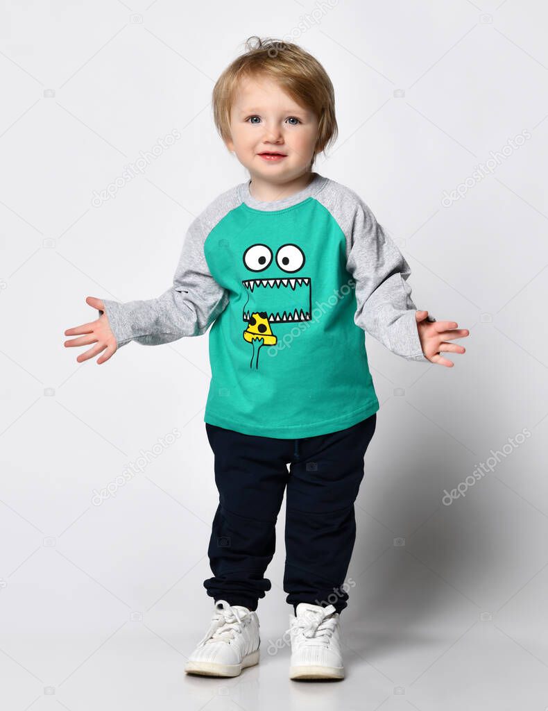 Little preschool toddler boy showing growth up gesture portrait