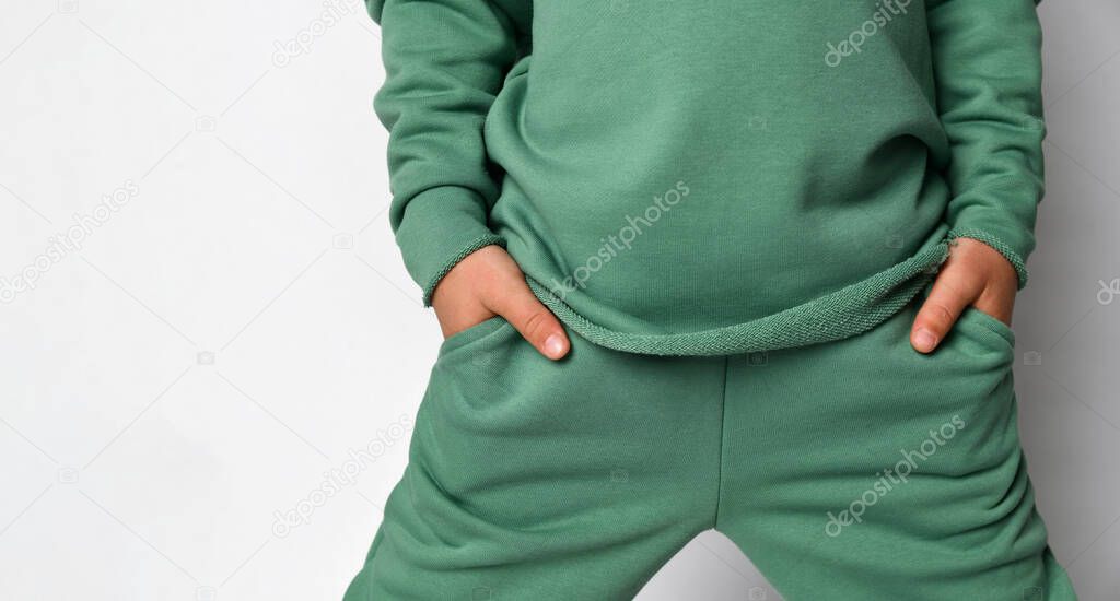 Cropped studio shot with child hand in pocket of sportswear