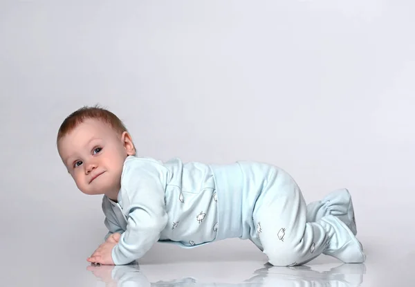 Creeping funny boy in body. He sits on the floor, isolated on a — Stock Photo, Image