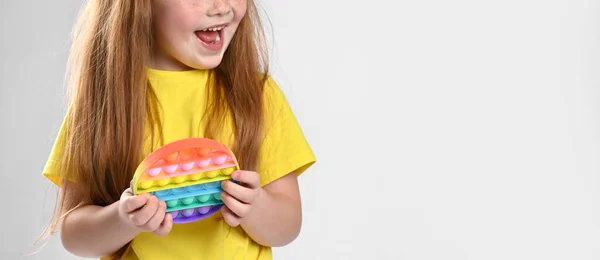 Pequena criança menina ruiva com pop-lo mostrando emoção surpreso — Fotografia de Stock