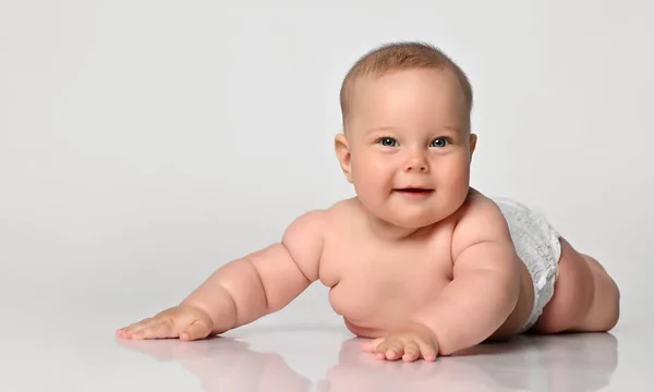 6 month old baby infant lies in one diaper on a light background — Stock Photo, Image