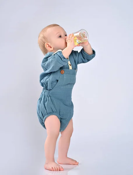 Adorable child drinking from bottle. — Stock Photo, Image