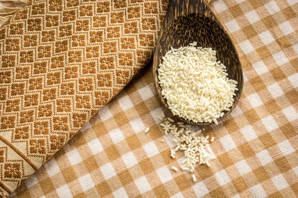 Lžíce rýže na stůl, pokrytý bavlna. — Stock fotografie