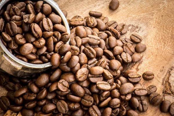 Roasted Columbian coffee beans placed on a wooden table. — Stock Photo, Image