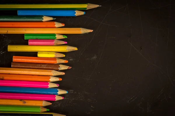 Dramatic group of pencils on black or dark background. — Stock Photo, Image