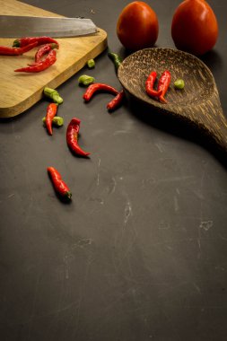 Young spring vegetables on black chalkboard from above. Backgrou