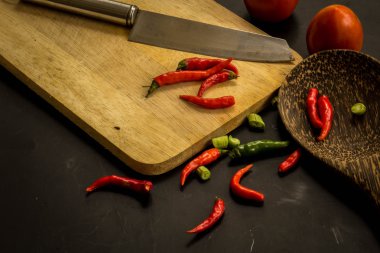 Young spring vegetables on black chalkboard from above. Backgrou
