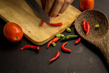 Young spring vegetables on black chalkboard from above. Backgrou
