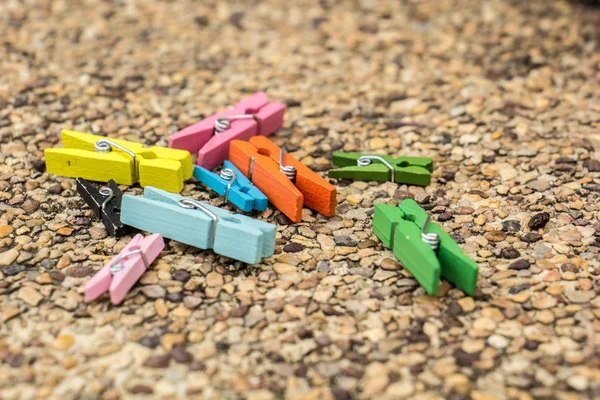 Wooden clothespin hanging on rope, depth of field — Stock Photo, Image