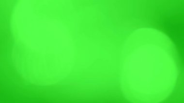 Yumuşak ışık sızıntıları ve yansımaları olan soyut yeşil ekran bokeh arkaplanı