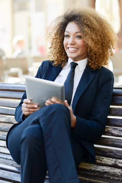Black woman using tablet computer in town — Stock Photo, Image