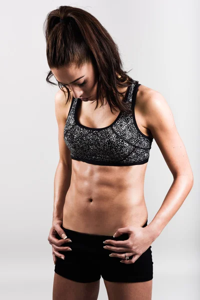 Mladý sportovní sexy fitness ženského těla na bílém pozadí — Stock fotografie