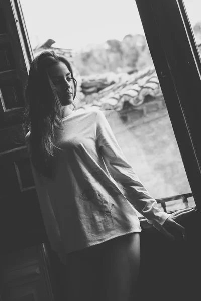 Woman in pyjama and white panties posing near a window — Stock Photo, Image