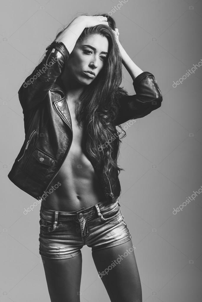 Woman In Denim Jeans Shorts And Black Leather Jacket Stock Beautiful Woman In Denim Jeans Shorts And Black Leather Jacket White Studio Shot