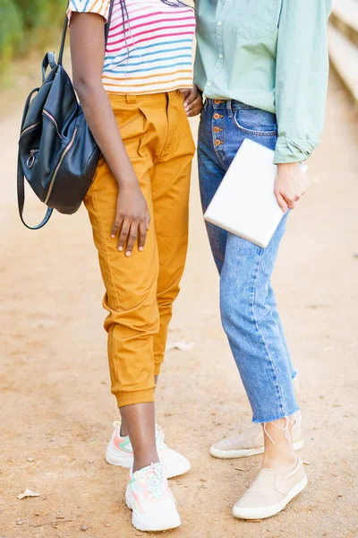Two unrecognizable multiethnic girls posing together with colorful casual clothing — Stock Photo, Image
